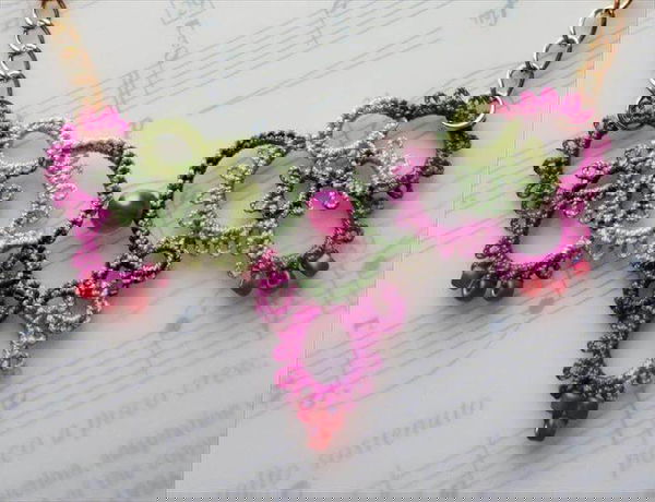 ochet jewelry pink crochet necklace laying on music book