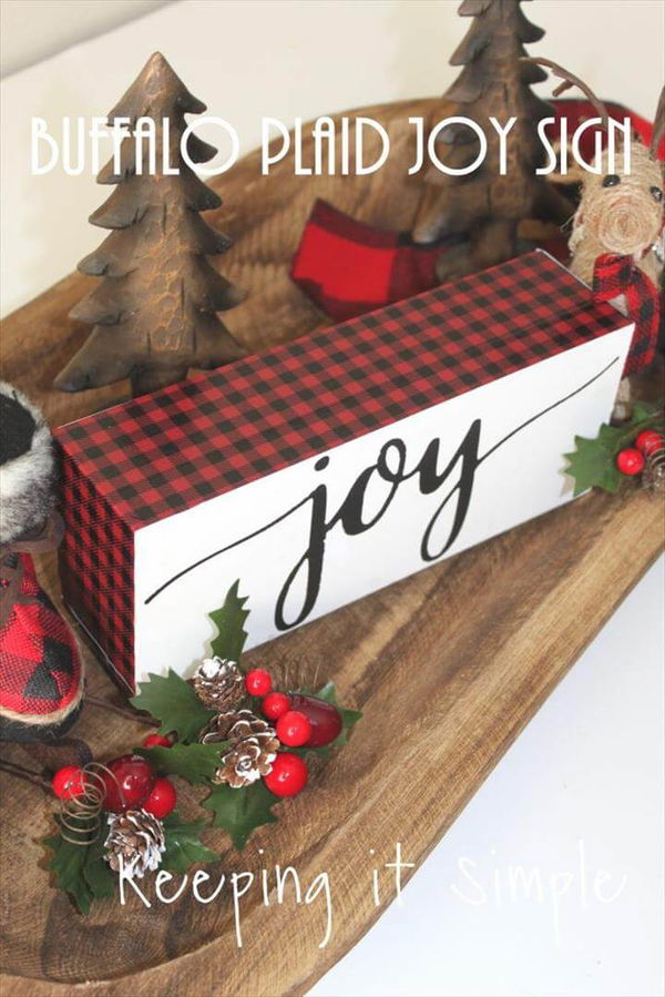 This red buffalo plaid Christmas joy block is super easy to make and looks amazing with lots of other fun Christmas decor.